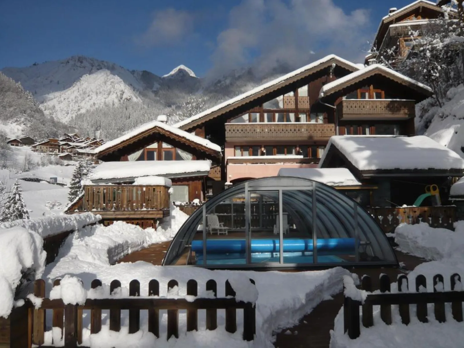 Résidence Les Edelweiss alpine apartments with wooden balconies on a snowy slope in Champagny-en-Vanoise